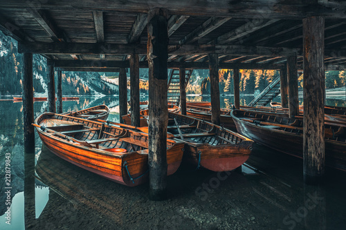 Boats on the Braies Lake ( Pragser Wildsee ) in Dolomites mountains, Sudtirol, Italy photo