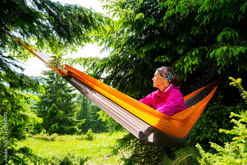 Adventurer female relaxes in hammock