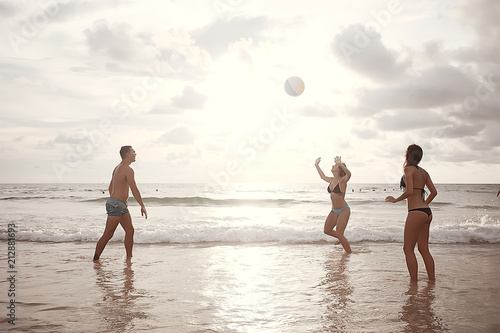 friends play a ball in the water / fun in summer vacation game with a ball in the water
