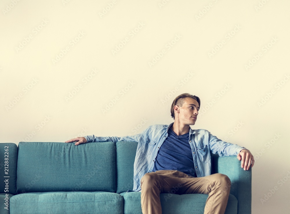 Man sitting on sofa alone Man sitting on sofa alone