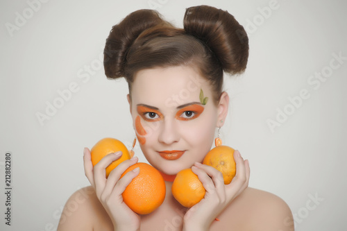 Beautiful girl with oranges. Portrait, female. photo