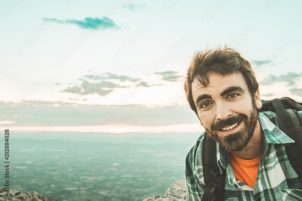 Guy with a beard smiling in the mountains .Man looked at the camera and smiled Guy with a beard smiling in the mountains .Man looked at the camera and smiled