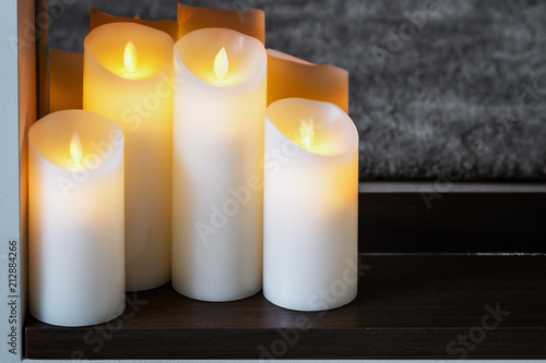 led electric candles stand in the home fireplace