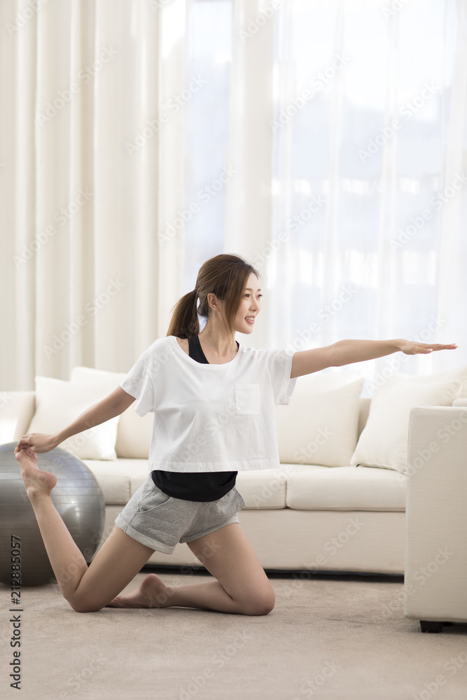 Young Chinese woman practicing yoga at home Young Chinese woman practicing yoga at home