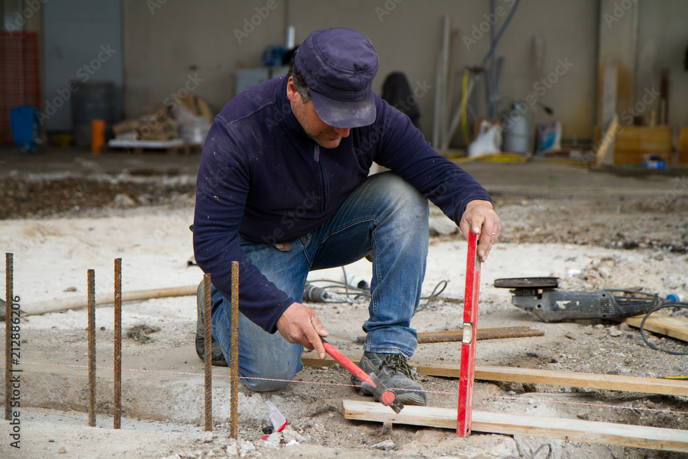 bricklayer at work in a building site bricklayer at work in a building site