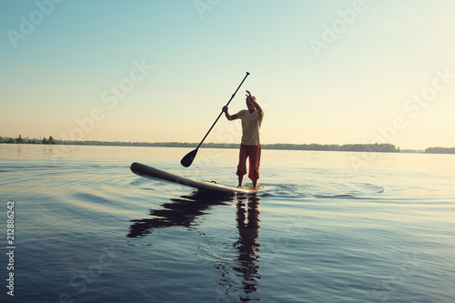 Man is training on a SUP board