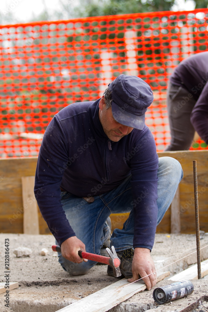 bricklayer at work in a building site bricklayer at work in a building site