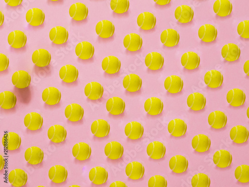 Fototapeta Naklejka Na Ścianę i Meble -  Yellow tennis ball pattern on pink background