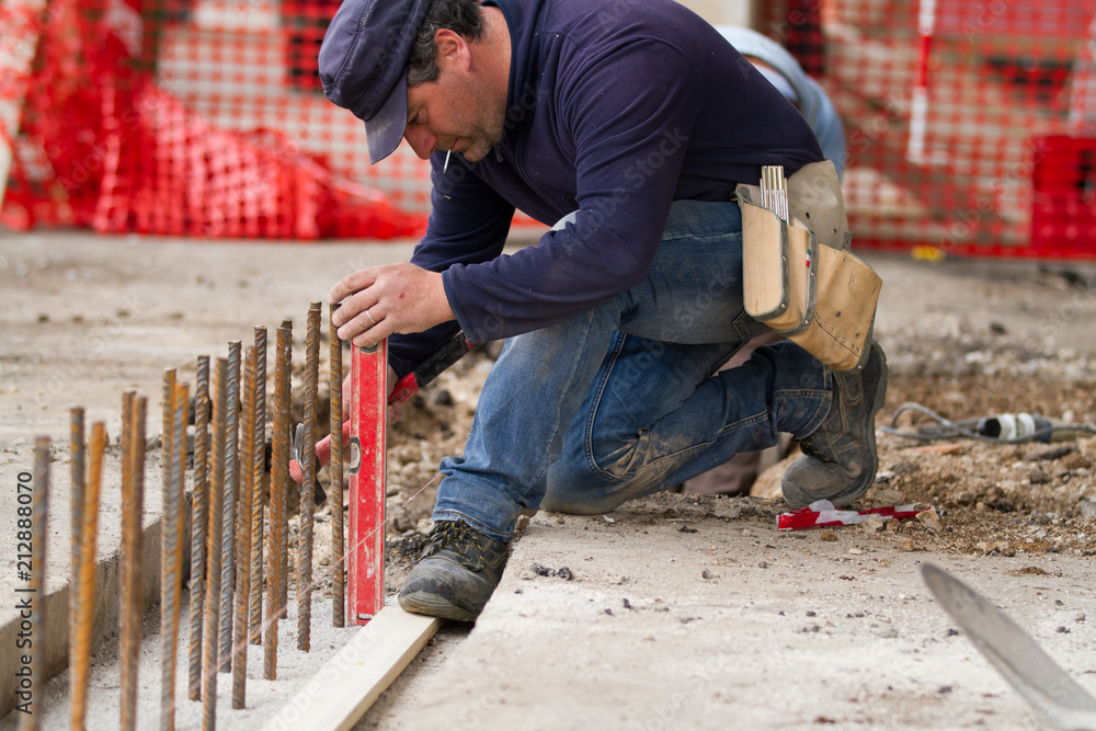 bricklayer at work in a building site bricklayer at work in a building site