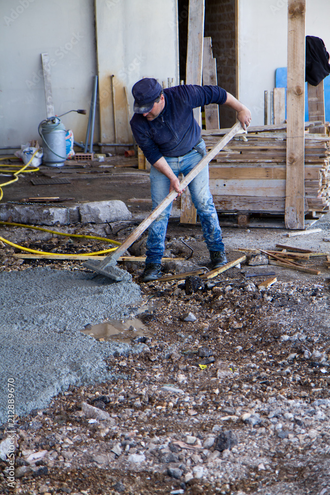bricklayer at work in a building site bricklayer at work in a building site