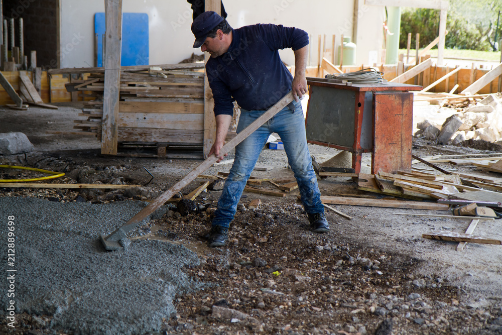 bricklayer at work in a building site bricklayer at work in a building site