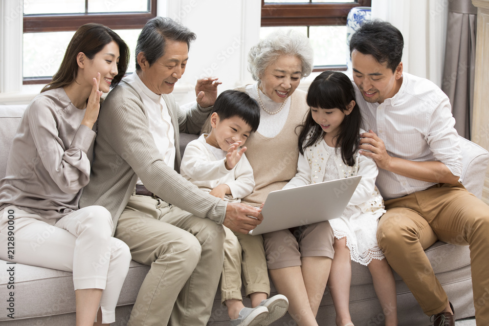 Happy family making video call on laptop at home Happy family making video call on laptop at home
