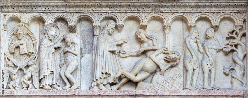 MODENA, ITALY - APRIL 14, 2018: The romanesque relief of creation of the man and woman on the facade of Duomo di Modena.