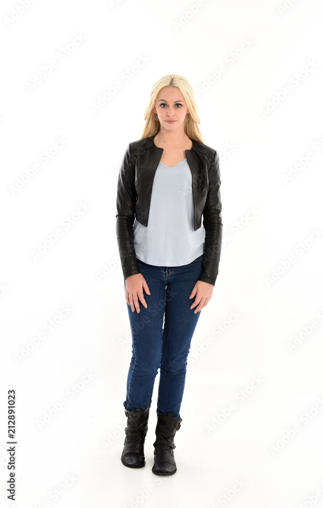 full length portrait of blonde girl wearing casual blue shirt and leather jacket. standing pose, isolated on white studio background. full length portrait of blonde girl wearing casual blue shirt and leather jacket. standing pose, isolated on white studio background.