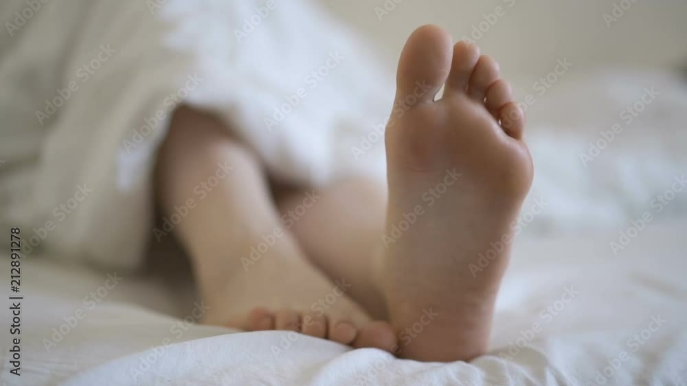 Movement of toes, attractive girl in bed Movement of toes, attractive girl in bed