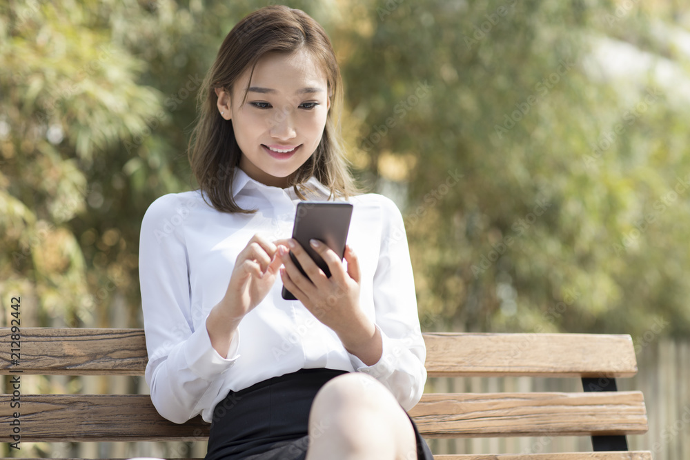 Young Chinese businesswoman using smart phone Young Chinese businesswoman using smart phone