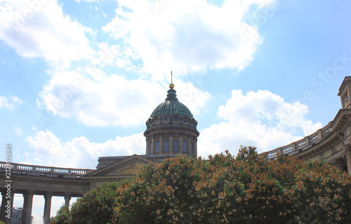 Kazan Cathedral Summer View in Saint Petersburg, Russia. Christian Orthodox Cathedral and Museum, Old City Landmark Facade Close Up. Kazan Cathedral on Sunny Day with Clouds on Blue Sky Background