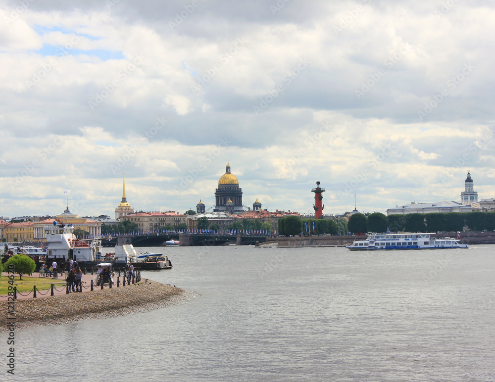 Saint Petersburg (Russia) City Skyline with Cruise Boats on Neva River, St Isaac's Cathedral and Rostral Columns on Background. St. Petersburg Architecture Cityscape View on Dark Cloudy Summer Day.