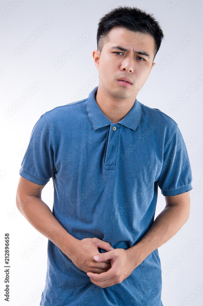 Man putting his hands for belly or stomach ache on white background Man putting his hands for belly or stomach ache on white background