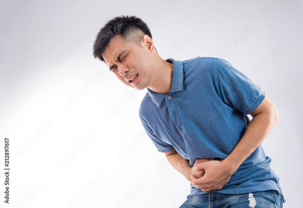 Man putting his hands for belly or stomach ache on white background Man putting his hands for belly or stomach ache on white background