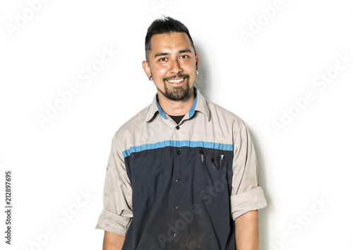 Handsome auto mechanic on white background photo