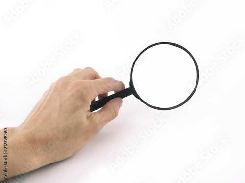 close up. magnifying glass in hand businessman.photo with copy s