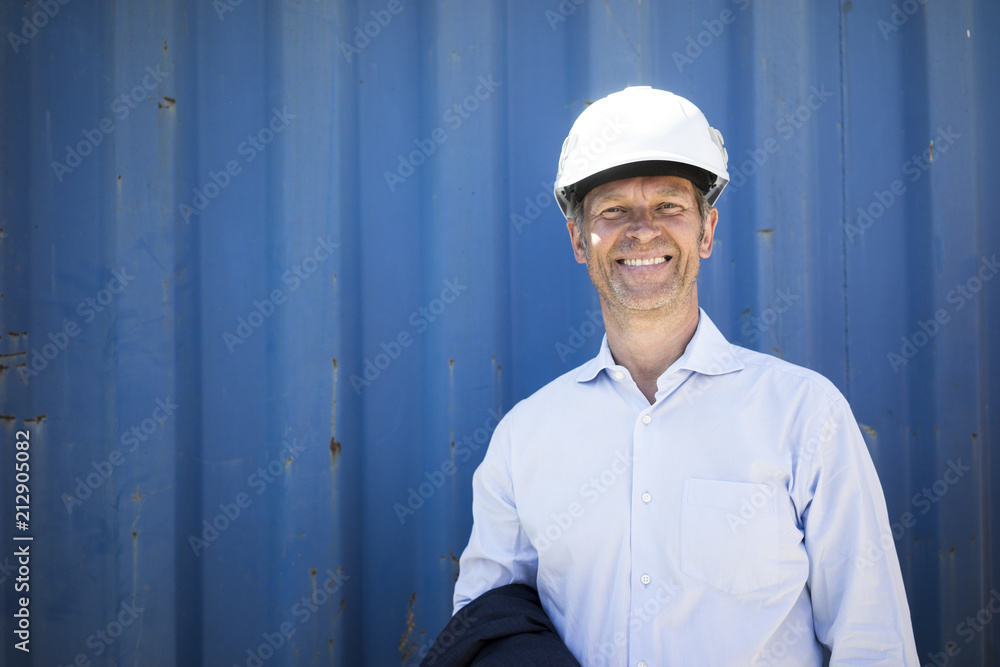 Portrait of smiling man wearing shirt and hard hat Portrait of smiling man wearing shirt and hard hat