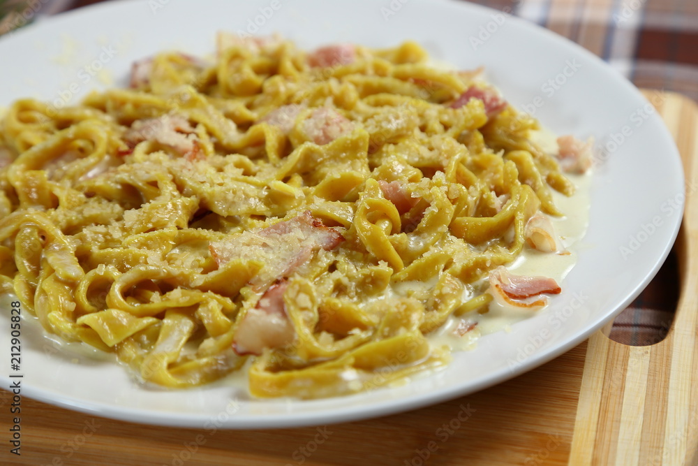 Macaroni of Carbonara with smoked sausage, bacon, sauce. Tasty lunch in the Italian restaurant with herbs, dill Macaroni of Carbonara with smoked sausage, bacon, sauce. Tasty lunch in the Italian restaurant with herbs, dill