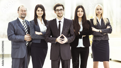 concept of success in business: professional business team on office background