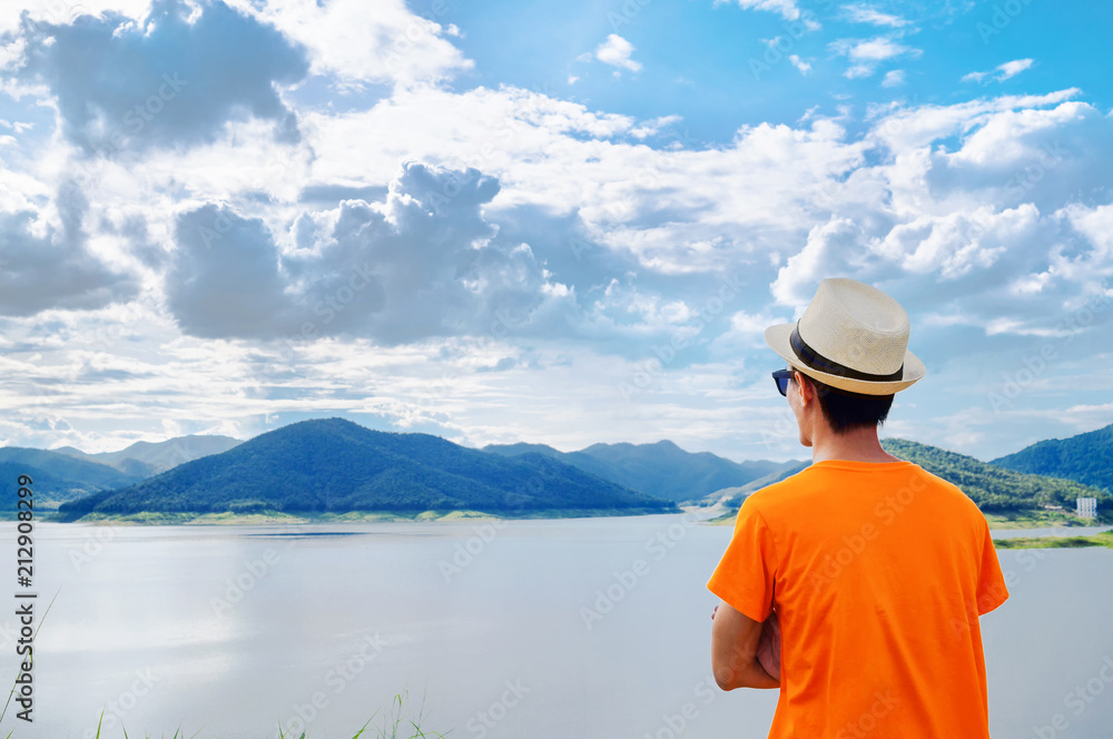 Young man traveller with reservoir and mountain sunset time. Young man traveller with reservoir and mountain sunset time.