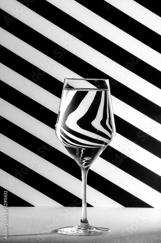 a glass in front of a black and white background