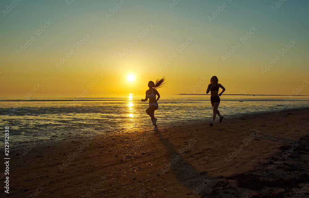 two girl running by the sea on the beach two girl running by the sea on the beach