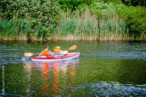 Fototapeta Naklejka Na Ścianę i Meble -  Tourists floating in a canoe on the river 