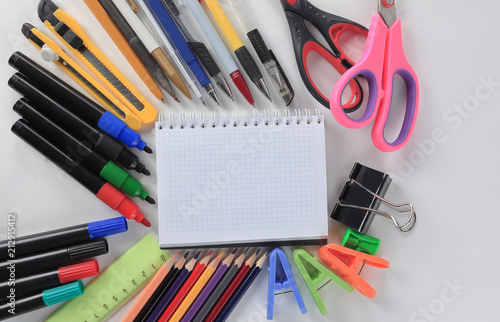opened Notepad and office supplies on white background.photo with copy space