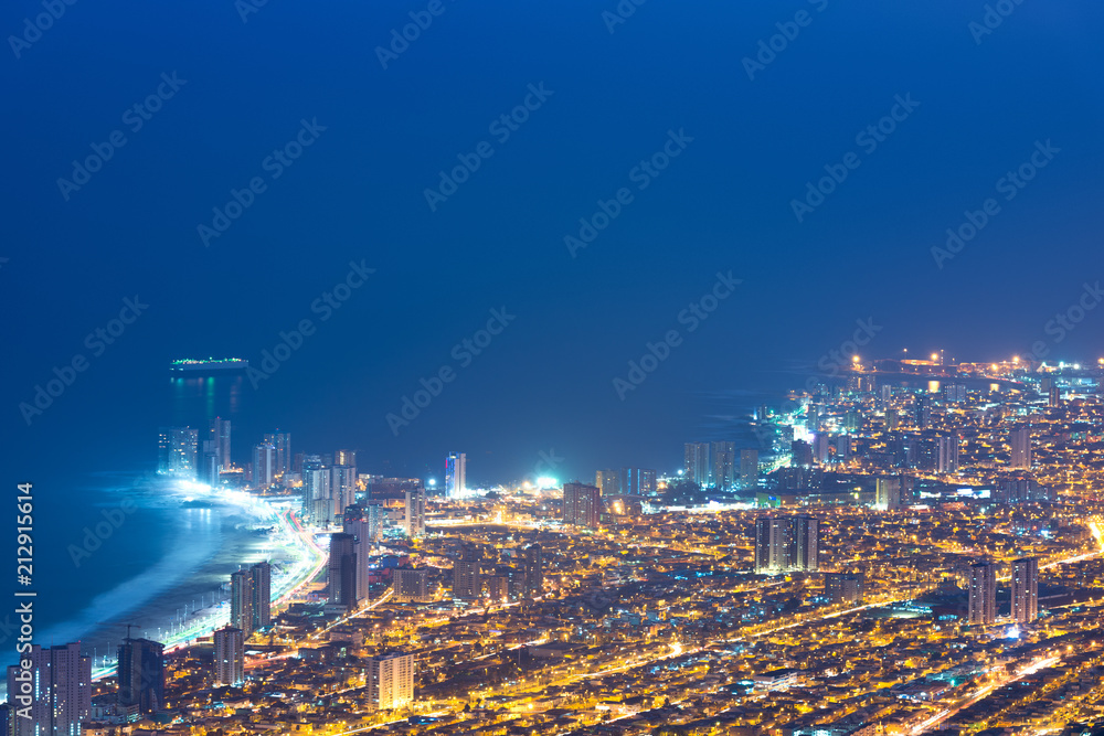Naklejka premium Aerial view of the port city of Iquique in the coast of the Atacama desert at dawn, Chile