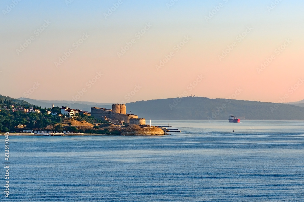 Entrance to Dardanelles (Canakkale strait) in morning haze from Aegean Sea with Ottoman fortress Kilitbahir ahead