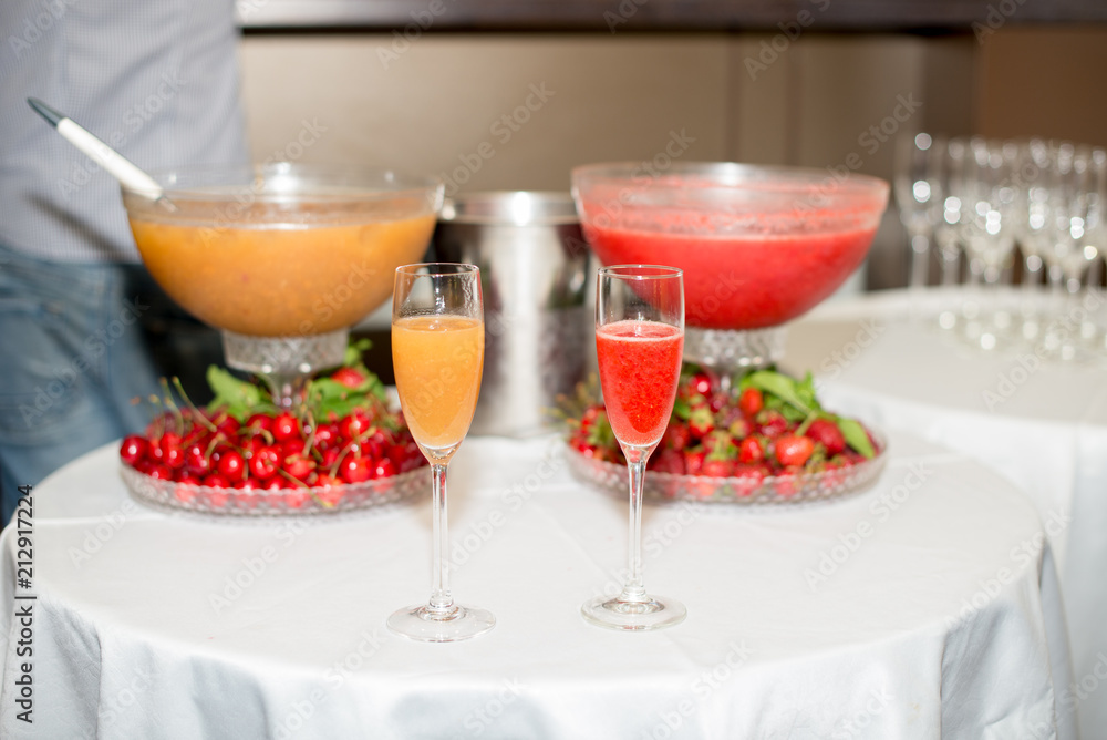 cocktail in a glass of champagne, punch and fruit in the background cocktail in a glass of champagne, punch and fruit in the background