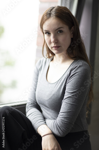 Beauty Portrait of a Young Woman Seated by Window