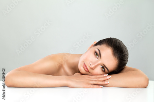 Attractive Spa Model Woman with Healthy Skin on White Background. Cosmetology, Facial Treatment and Spa Beauty Concept