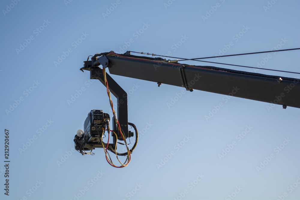 4K cinema production camera with crane in the blue sky. mass movie industrial. 4K cinema production camera with crane in the blue sky. mass movie industrial.