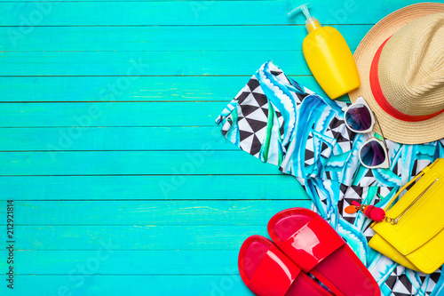 Composition with swimsuit on color wooden background