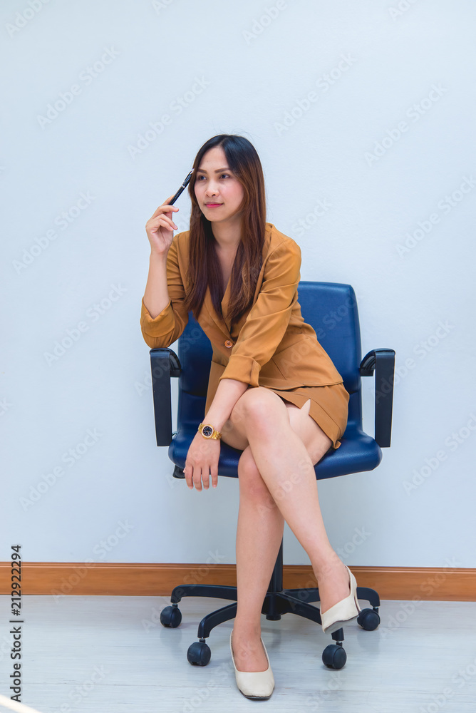 Portrait of beautiful asian business woman wear yellow dress in a ...