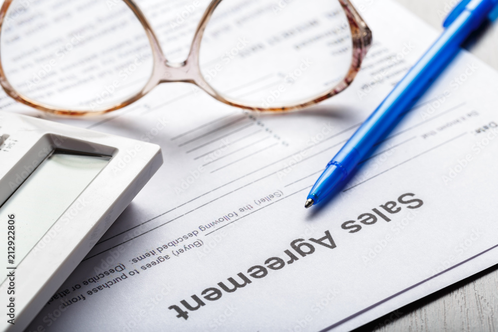 Close up shot of Eyeglasses on contract document papers business concept Close up shot of Eyeglasses on contract document papers business concept