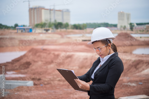 Engineer woman working at site of bridge under construction