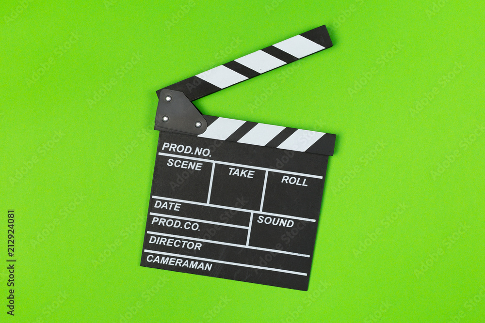 Film clapper board on green background top view