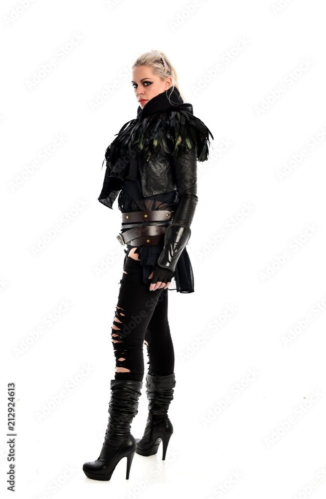 full length portrait of blonde girl wearing torn black feather costume. standing pose, isolated on white background. full length portrait of blonde girl wearing torn black feather costume. standing pose, isolated on white background.