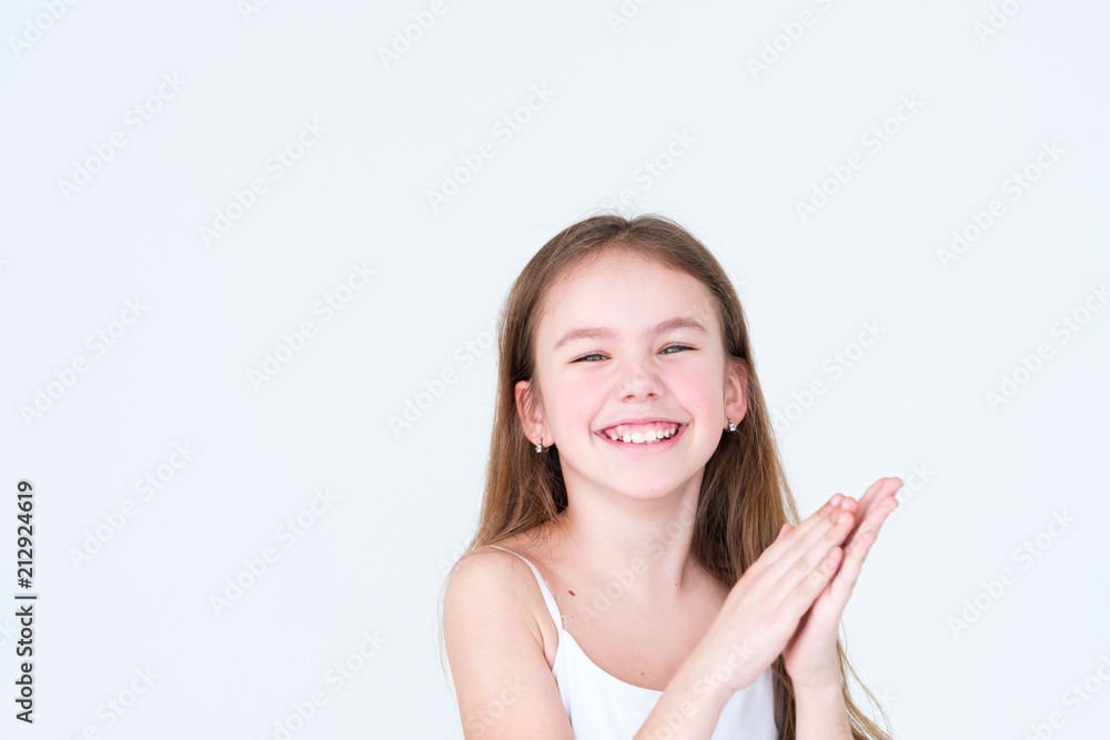 emotion face. happy joyful delighted kid clapping her hands. little girl portrait on white background. mood feelings personality and facial expression concept emotion face. happy joyful delighted kid clapping her hands. little girl portrait on white background. mood feelings personality and facial expression concept