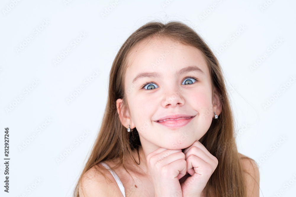 Fotografia do Stock: emotion face. mischievous playful prankish naughty kid  making faces and smiling. little girl portrait on white background. mood  feelings personality and facial expression concept | Adobe Stock