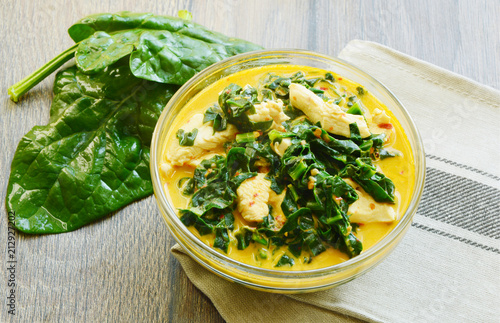 Spinach and chicken breast  with curry and coconut soup Thai menu. ( Thai name is Gaeng Om kai  pak khom)