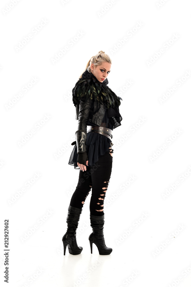 full length portrait of blonde girl wearing torn black feather costume. standing pose, isolated on white background. full length portrait of blonde girl wearing torn black feather costume. standing pose, isolated on white background.